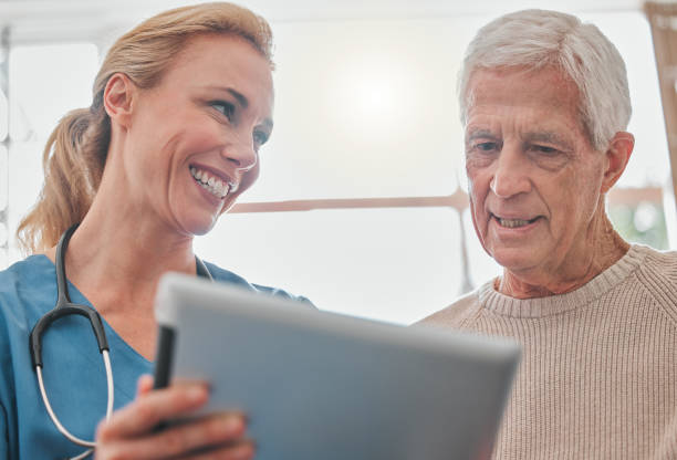 istock Shot of a nurse using a digital tablet with her elderly patient 1368361262