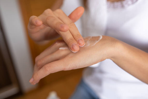 istock Woman Moisturizing Her Hands with Lotion 1368362845