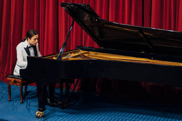 istock A young and dedicated pianist practicing his piano playing skill before a performance,
in the theater. 1368363371