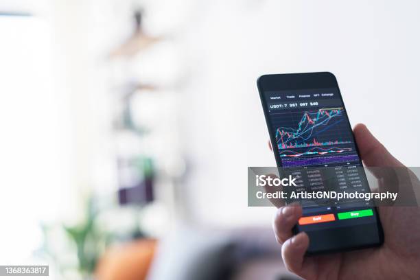 Businessman Reading Financial Stock Market Analysis On Smartphone Stock Photo - Download Image Now
