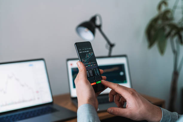 istock Businessman buying cryptocurrency through mobile phone app. 1368363818
