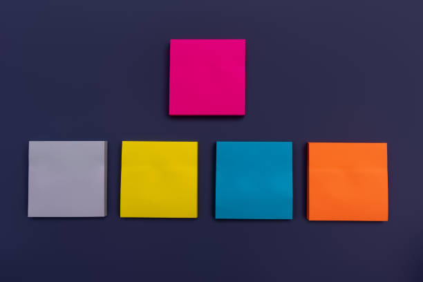 istock Collection of different colored sheets of note papers ready for your message on dark blue background. Front view. Close up 1368364348