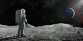 istock Astronaut Standing On The Moon Looking Towards A Distant Earth 1368368019