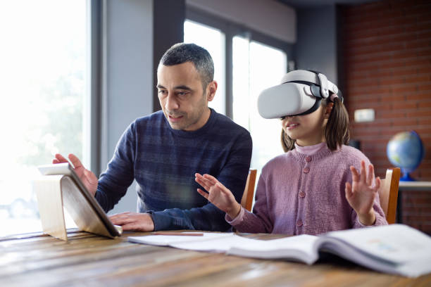 istock Father Assisting Her Daughter Doing Homework Via Metaverse 1368369858