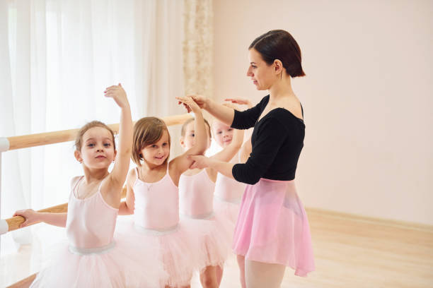 istock Working with coach. Little ballerinas preparing for performance by practicing dance moves 1368370270