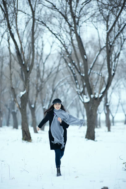 Young women running on snow ground