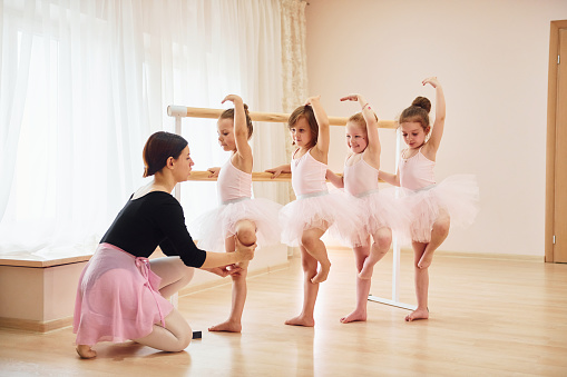 Practicing pose. Little ballerinas preparing for performance.