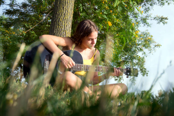 Girl playing acoustic guitar