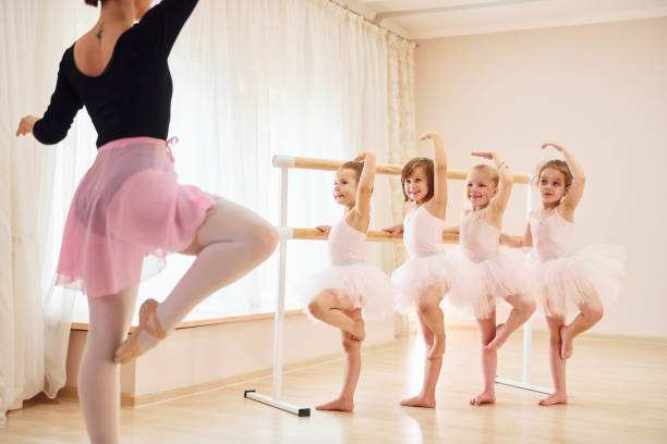 Practicing pose. Little ballerinas preparing for performance stock photo