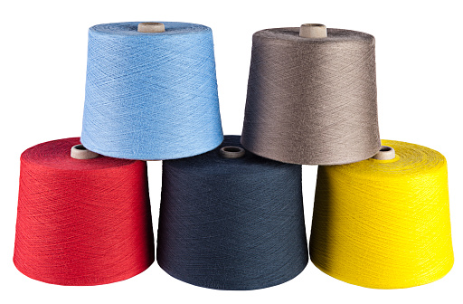 A big spool of multi colored sewing threads isolated on white background (with clipping path)
