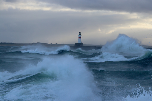 Stormy waves and breakwater beacon