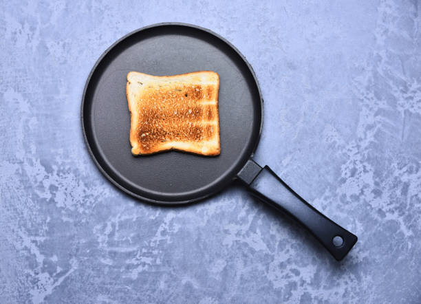 istock Grilled sandwich cooking in large frying pan on grey background 1368375135
