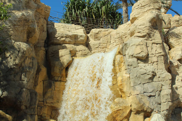 A small waterfall draining from a rocky mountain. Close-up. Landscape.