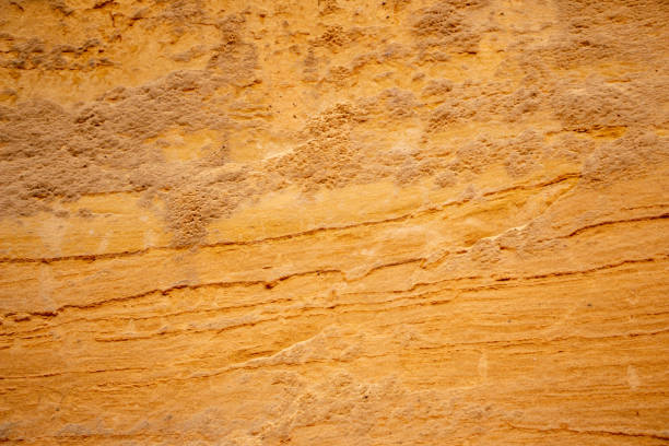 istock Textural sand, with  relief surface, multi-colored layers and different in size of granules, in outdoor sand career, after mining ore and sand for construction. 1368376204
