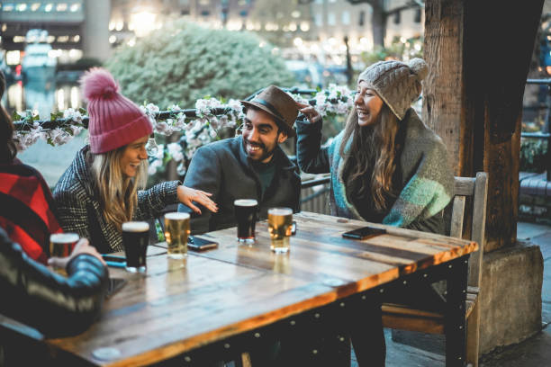 istock Young people having fun drinking beer at pub restaurant - Soft focus on center guy face 1368376219