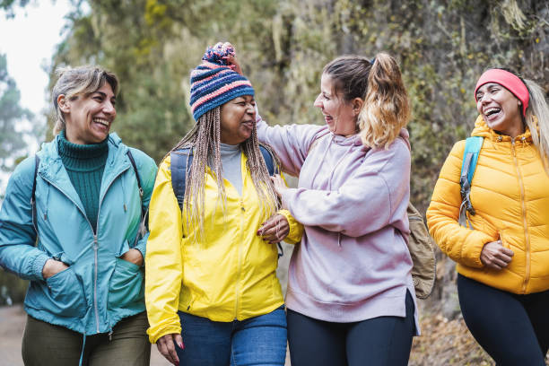 istock Multiracial women having fun during trekking day in mountain forest - Focus on faces 1368376240