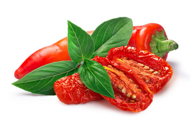istock Dried or Sundried tomato halves with chile  pepper and basil isolated 1368376754
