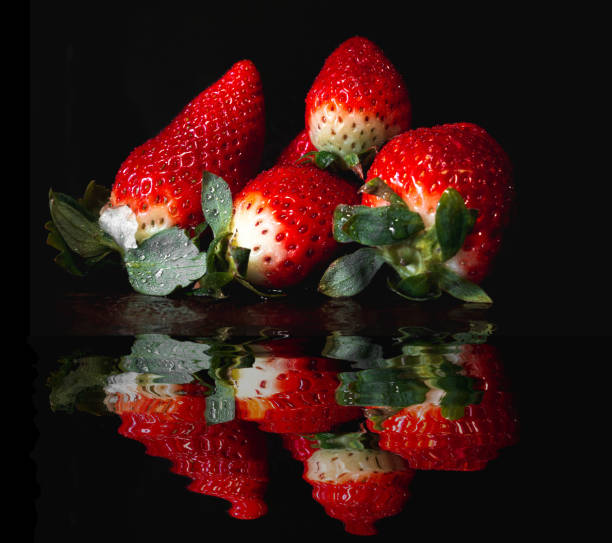 istock Group of strawberries reflected in water. 1368377474