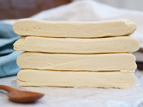 A stack of uncooked puff pastry dough, also known as pâte feuilletée. Composed with dough and butter folding in a dough, a traditional French recipe