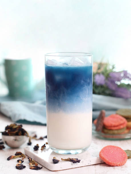 A glass of iced butterfly pea flower milk tea latte