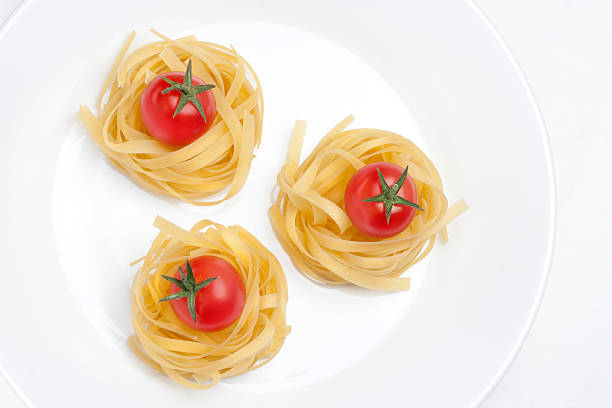 italian pasta nests on white plate