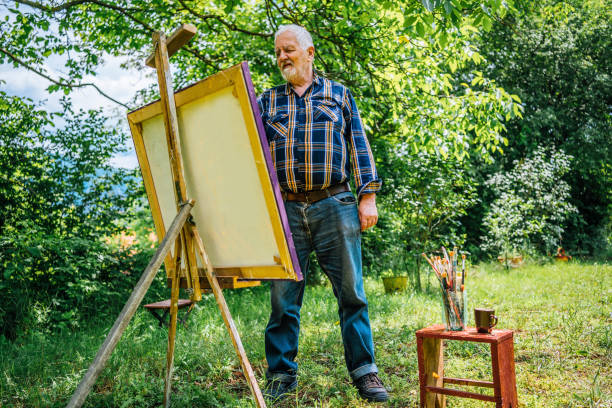 istock Elderly man painting on a canvas 1368378339