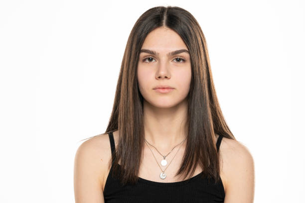 portrait of a beautiful teenage girl with long straight hair and no makeup portrait of a beautiful teenage girl with long straight hair and no makeup on a white background half dressed girls pictures stock pictures, royalty-free photos & images