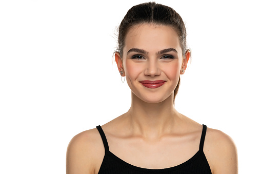 portrait of a smiling teen girl with closed mouth on a white background