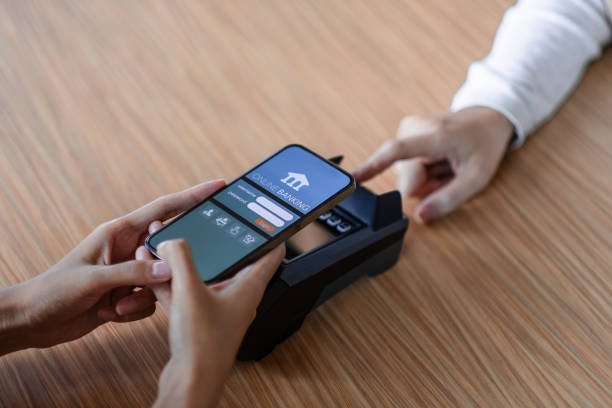 istock Close up customer make mobile payment contactless paying with NFC technology on smart phone. 1368379755