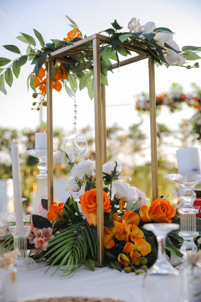 istock table center decor with orange flowers and greenery 1368379907
