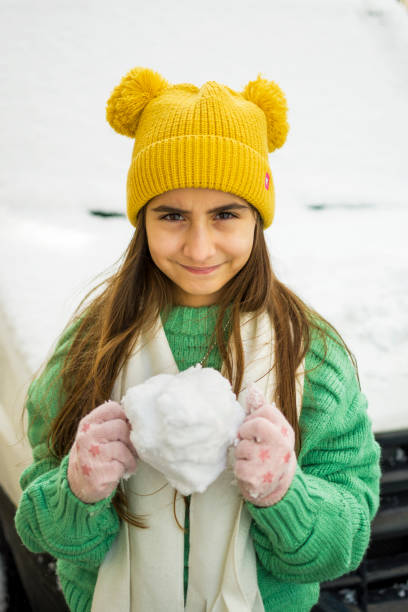 Girl playing in the snowy park