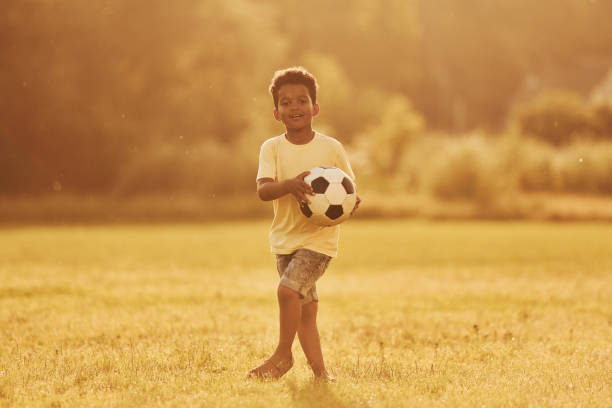 istock Active weekend time spending. African american kid have fun in the field at summer daytime 1368382445