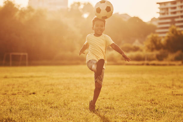 istock Active weekend time spending. African american kid have fun in the field at summer daytime 1368382446