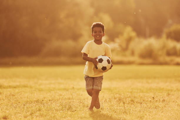 istock Active weekend time spending. African american kid have fun in the field at summer daytime 1368382457