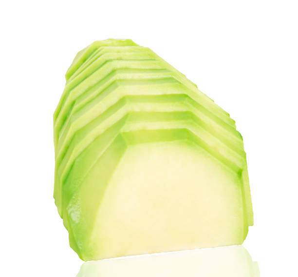 istock Sliced pieces of avocado on a white isolated background. 1368382465