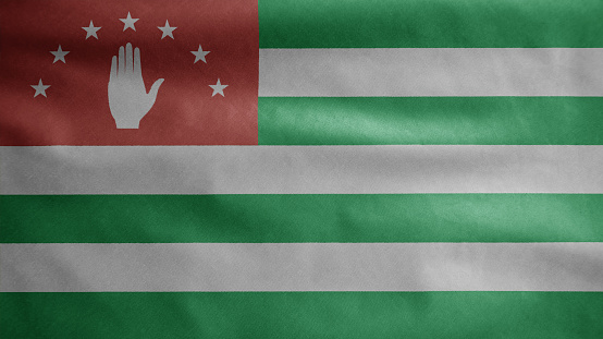 Abkhazian flag waving in the wind. Close up of Abkhazia banner blowing, soft and smooth silk. Cloth fabric texture ensign background. Use it for national day and country occasions concept.