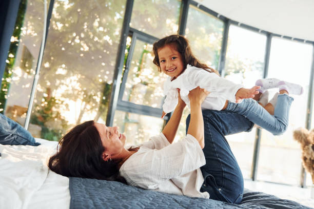 istock Playing together. Mother and her daughter spending time at home 1368383630
