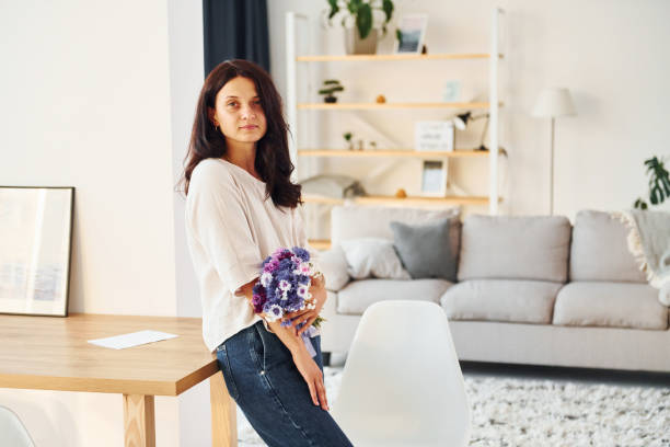 istock Young woman is at home alone. Modern design and interior 1368384287