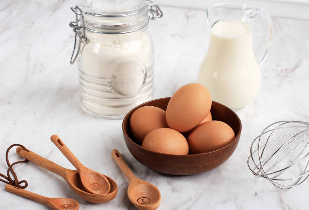 istock eggs, flour, milk, sugar and wire whisk 1368384373