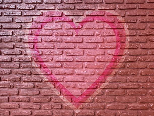istock old brick wall graffiti heart, valentines day background 1368387372