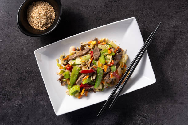 istock Beef, vegetables and sesame seeds in black bowl 1368388344