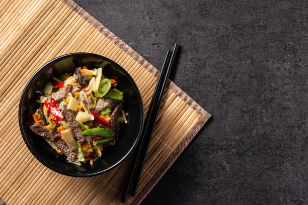 istock Beef, vegetables and sesame seeds in black bowl 1368388405