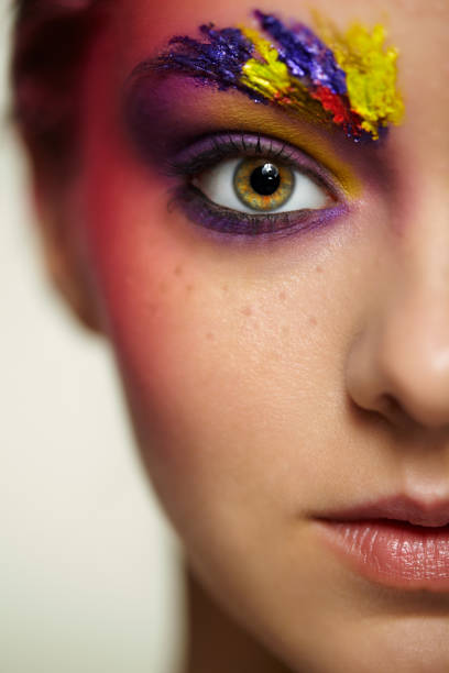 istock Unusual female face art make-up with paint on brows and around eyes. 1368389567