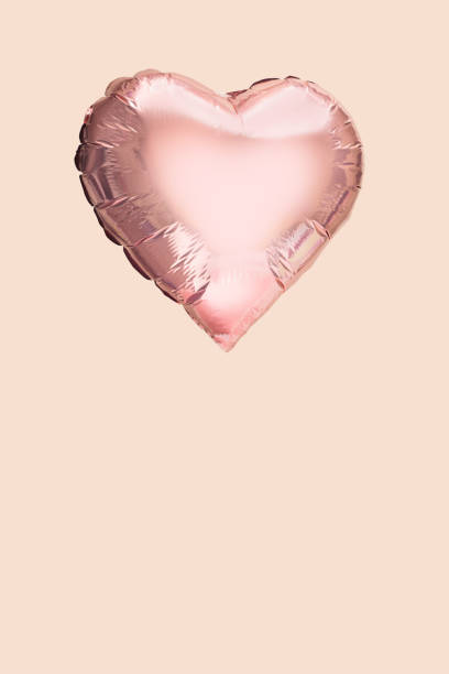 istock A heart shaped  pink color balloon on pink background with copy space. 1368389604