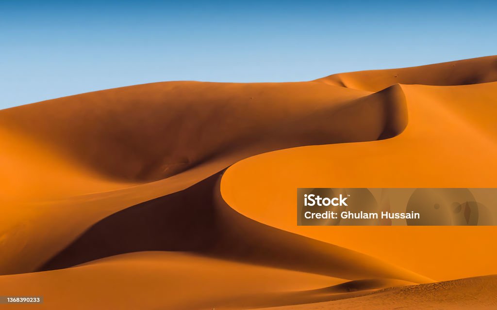 Sand dunes in the Sahara desert Beautiful shape of sand dunes in the Niger Sand Dune Stock Photo