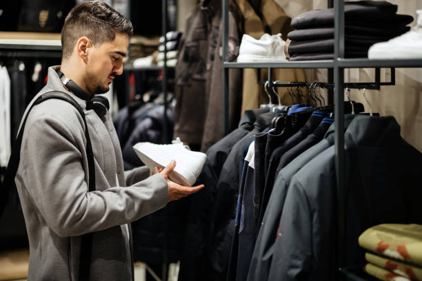 istock Young Businessman shopping in clothes store 1368390735