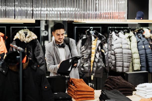 istock Young Businessman shopping in clothes store 1368390744