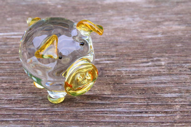 istock Glass yellow pig and old board. Close-up. Background. Texture. 1368392532