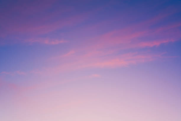 Crimson sunset with clouds. Magenta sky background. Purple clouds and blue sky