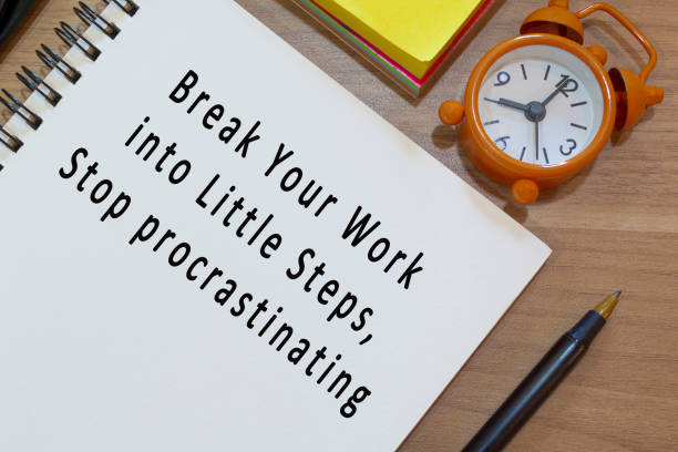 istock Text on notepad with alarm clock on wooden desk. Work concept 1368392705